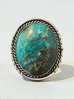 Front view of bolo slide showing turquoise stone and sterling bezel