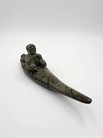 Oblique view of full sculpture showing hunter and kayak profile