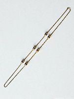 Full view of gold-tone rope necklace showing length and station placement