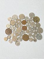 Overview of entire group of coins laid out on white background