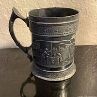 Front view showing relief scene and handle