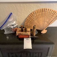 Group shot showing all items: Daisy BB boxes, Jet-Oil bottle, folding fan, Liquid Lustre bottle, wood cylinder