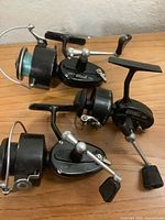All three spinning reels side by side showing model plates and handles