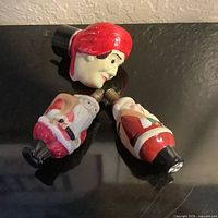 Three vintage figural screw-base bulbs showing Santa designs and Davy Crockett head