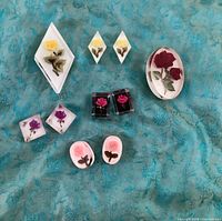 All ten lucite pieces laid out on fabric