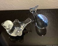 Songbird and whale glass figurines side by side