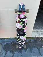 Full view of floral graphic underside showcasing complete longboard