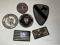 All six embroidered patches displayed on flat surface