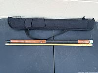 Cue disassembled alongside soft case