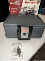 Closed Honeywell 2011 lock box with keys and retail box visible