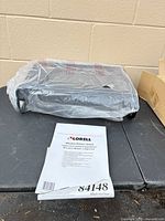 Sealed Lorell stand in plastic with instruction sheet visible