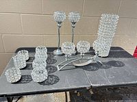 All ten rhinestone metal candle holders grouped on table