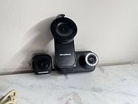 Front and rear cameras with suction mount displayed on surface