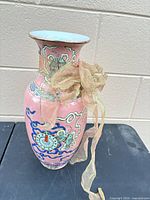 Full view of pink Chinese porcelain vase on table
