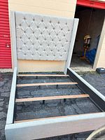 Full view of assembled bed frame without mattress showing headboard, side rails, footboard, and inner slats