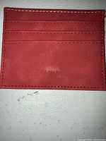 front view showing three card slots, logo, stitching
