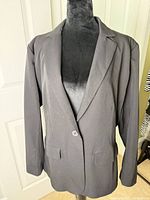 Front view of black blazer on mannequin