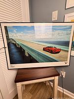 Framed Corvette C8 print leaning on stool