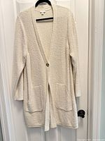 Full front view of cardigan on hanger