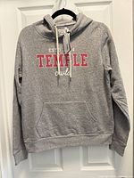 Full front view of heather gray League Temple Owls hoodie on hanger