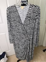 Full view of zebra faux-wrap dress on hanger
