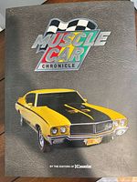 Front cover showing title, logo, and yellow muscle car image