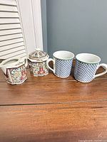Full lot showing two Villeroy & Boch mugs, Takahashi creamer and covered sugar bowl