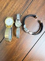 All three watches side by side on table