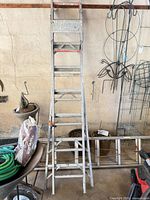 Full view of 7-ft aluminum A-frame ladder leaning against wall