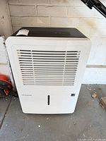 Front view showing grille and water-level window