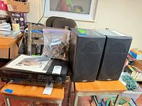 Overall lot showing Denon receiver, two Polk speakers, manuals, cables