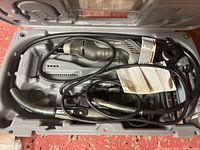 Open case showing rotary tool, flexible shaft, accessories