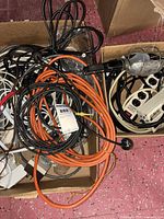 Mixed cords, orange extension, trouble light, power strip