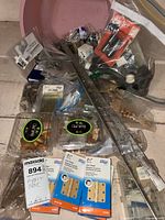 overview of packaged hinges, wood knobs, loose hardware and ruler