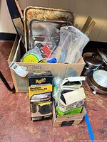 overview of box with paint trays, brushes, kits