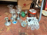 Group shot showing pewter holders, glass shades, votive jar, tealight holders, candles and accessories