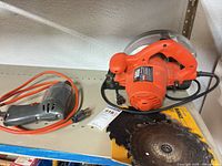 Circular saw, drill, extra blade on shelf