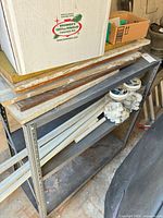 overall view of metal shelf with wood boards and PVC pieces