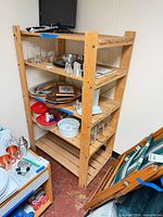 Front view of five-shelf wooden unit with slatted shelves