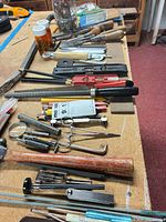 Overview of assorted hand tools laid on workbench