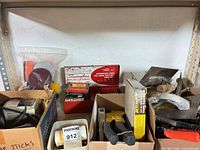 Overall view of three boxes of assorted tools, showing stapler packaging and glue sticks
