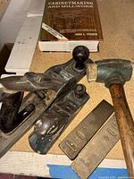 Overview of planes, mallet, wedges and book on workbench