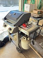 Front three-quarter view of Weber Spirit II grill with propane tank attached