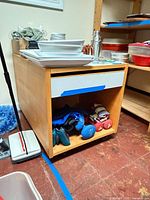 Table front view with contents removed, showing drawer closed, casters visible