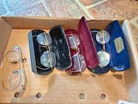 Tray with four pairs eyeglasses and three cases