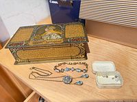 All items: metal box, bracelet, necklace, tin with stones