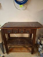 Full view of cabinet front showing drawers and lower shelf