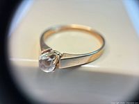 Close-up of ring showing stone setting and band detail