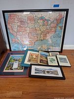 Group shot of all seven framed pieces including large USA map and six smaller prints