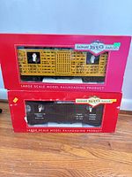 Front view of both Bachmann Big Haulers boxes showing yellow and brown stock cars